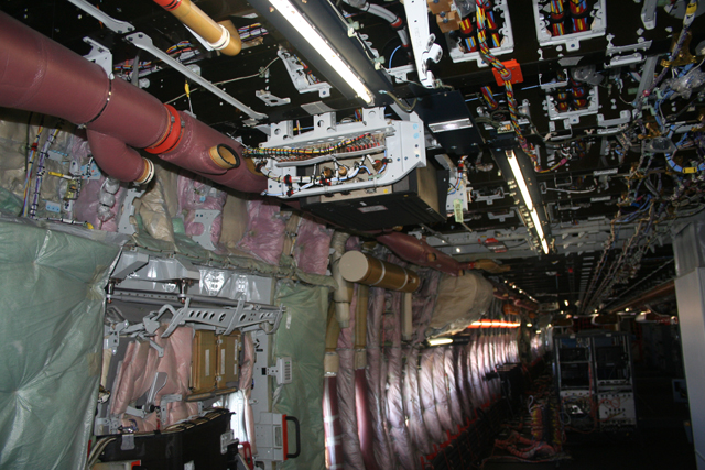 An A380 cabin with the covers removed.  (Photo R de Crespigny)