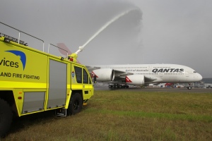 Airservices Aviation Rescue and Fire Fighting fire vehicles welcome home VH-OQA Nancy-Bird Walton at Sydney Airport.  (Courtesy AirServices)