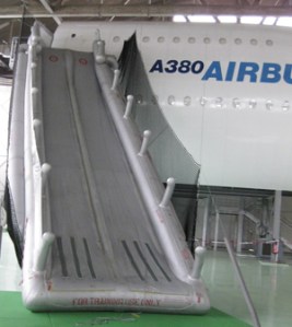 The escape slide from the 3 story (8 metre) high upper deck door sill. Rocket powered venturi pump inflates slides within 6 seconds (2/3 is fresh air). Inflates within 6 seconds. Withstands 25 kts (46 kmph) winds.